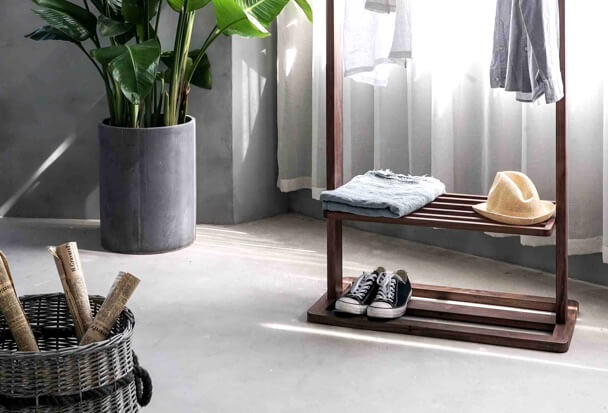 A plant and a clothing rack in a tidy room